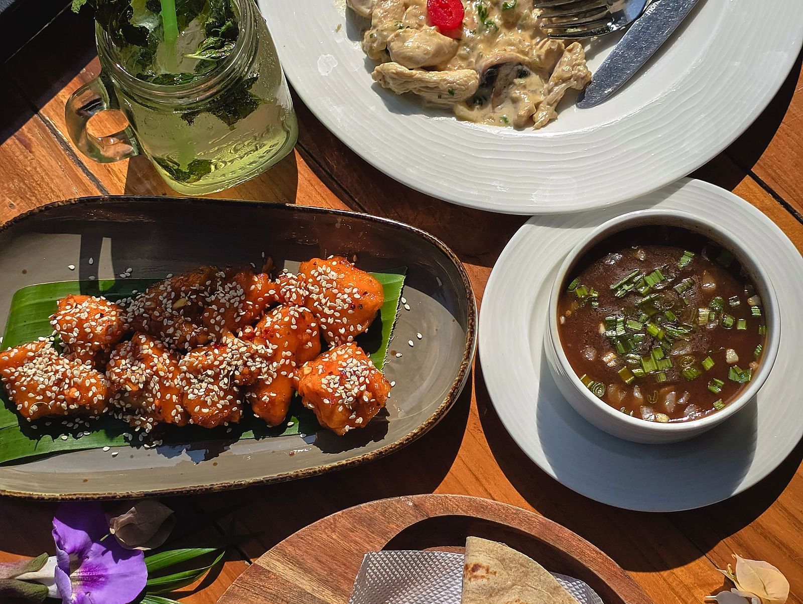 Traditional Indian meal with various dishes served on a round table at The Verda de Miranda Resort.