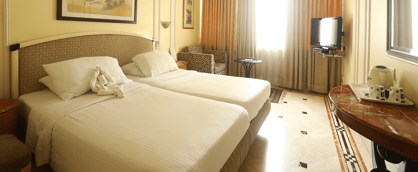Twin beds in the Standard Room at Regency Hotel, Mumbai.
