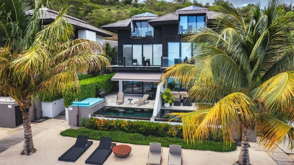 Lush garden and poolside area with luxury beachfront villas at Tamarind Hills Antigua – Resort & Villas