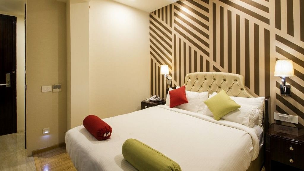 Standard room with bed and lamp on both the sides of the bed at Art Boutique Hotel, Hyderabad 