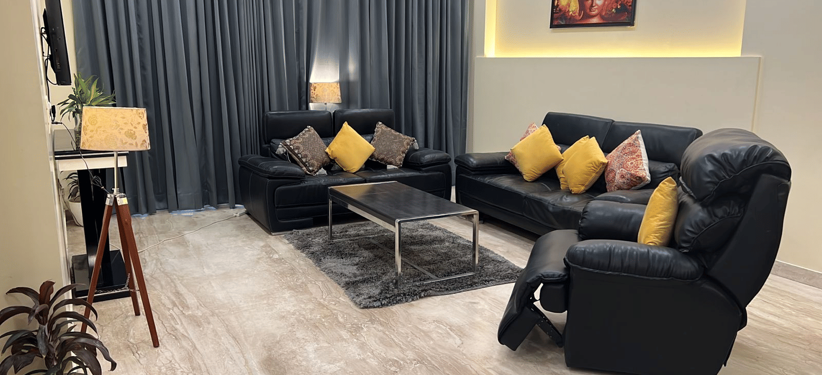 Sofas in front of the TV at Lime Tree 3BHK Serviced Apartments, DLF Phase - 5 Gurgaon