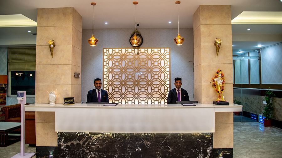 A front view of the reception with two people standing behind the desk | Sun Park Hotel & Banquet, Chandigarh - Zirakpur