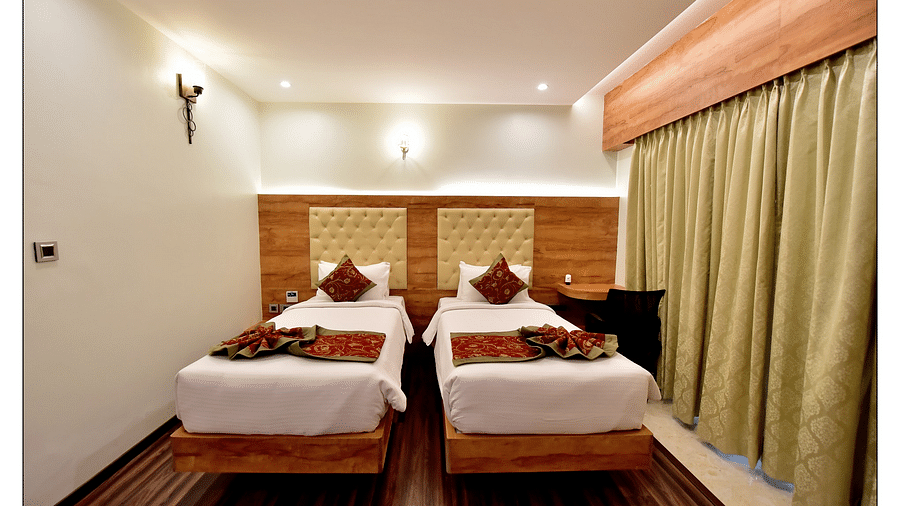 Royal Lotus View Resotel, Bangalore Bengaluru fron tview of standard room with twin beds and warm decor for a smooth stay - Royal Lotus View Resotel