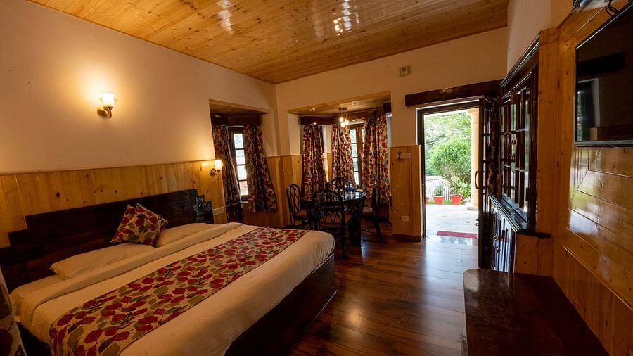 Side view of the family room with a cosy king-sized bed at The Pavilion, Nainital