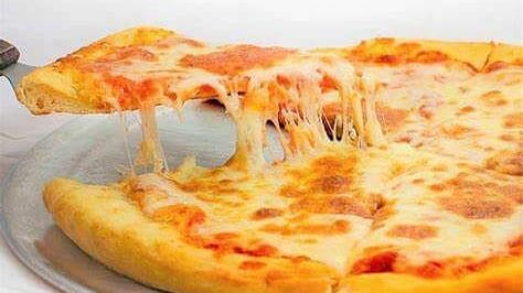A plate of cheese pizza with a slice lifted, served at Indie Stays, BKC Kalina.