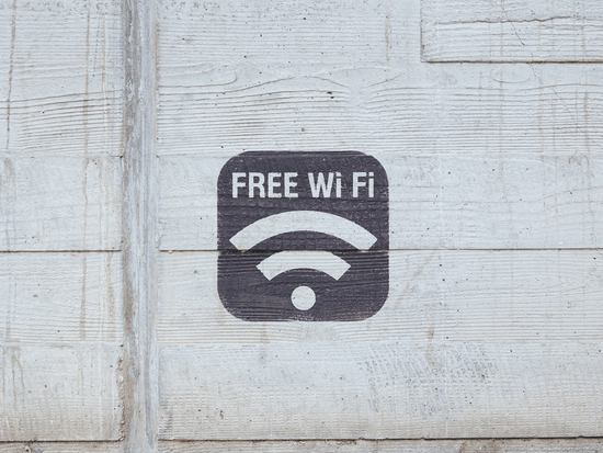 The words 'Free Wi-Fi' painted on a wall with the network symbol.