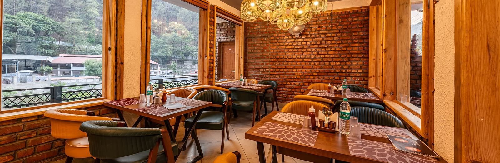 Corner view of the Kesari Restaurant by JVR Stays featuring a chandelier hanging from the ceiling.