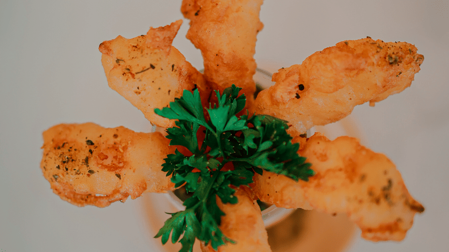 Star-shaped fried appetiser garnished with herbs at Hotel Mumbai House Digha, Airoli.