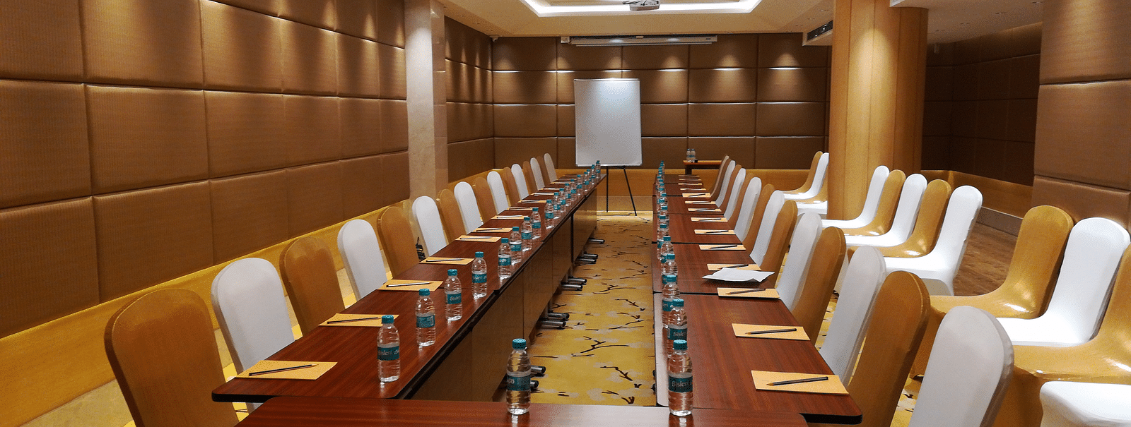 a meeting hall with a long rectangular table with chairs surrounding it - Hotel Fountain Tree By TGI - JP Nagar, Bangalore