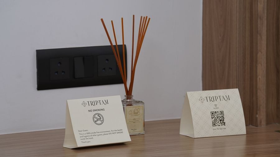 reed diffuser and notices in one of the rooms at Triptam Hotel, Vrindavan
