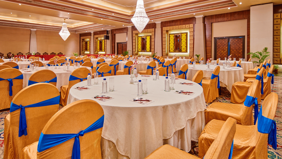 Celebration-ready banquet hall, featuring bright lighting and detailed decorations across the entire space.