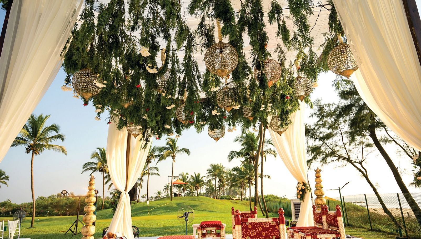 a mantap set up on the garden with decorations on it - Caravela Beach Resort Goa