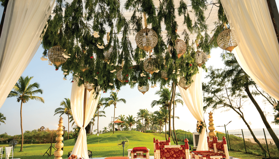 a mantap set up on the garden with decorations on it - Caravela Beach Resort Goa