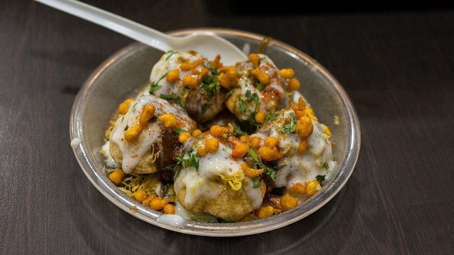 Dahi puri topped with sev and tangy green chutney
