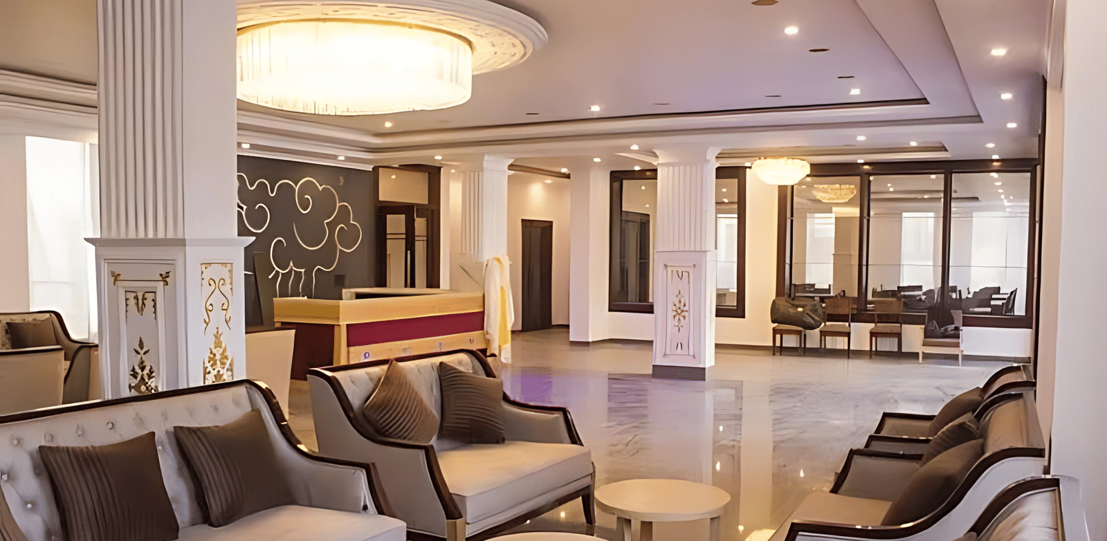 The main lobby of Hotel Dekiling by Eastlynn Collections, Leh showing a reception desk, plush seating arrangements, and a large circular ceiling light.