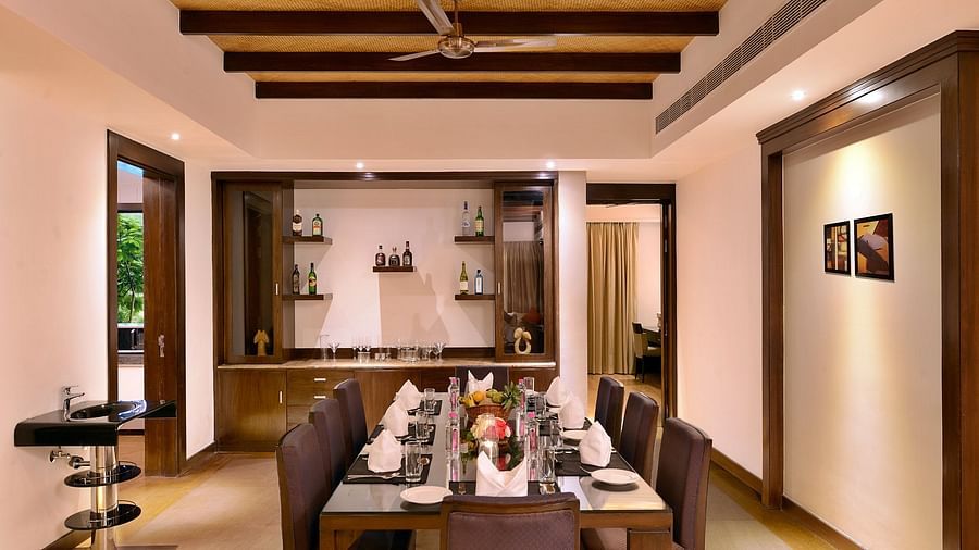Dining area with seats and a big table inside the presidential villa - Ananta Udaipur