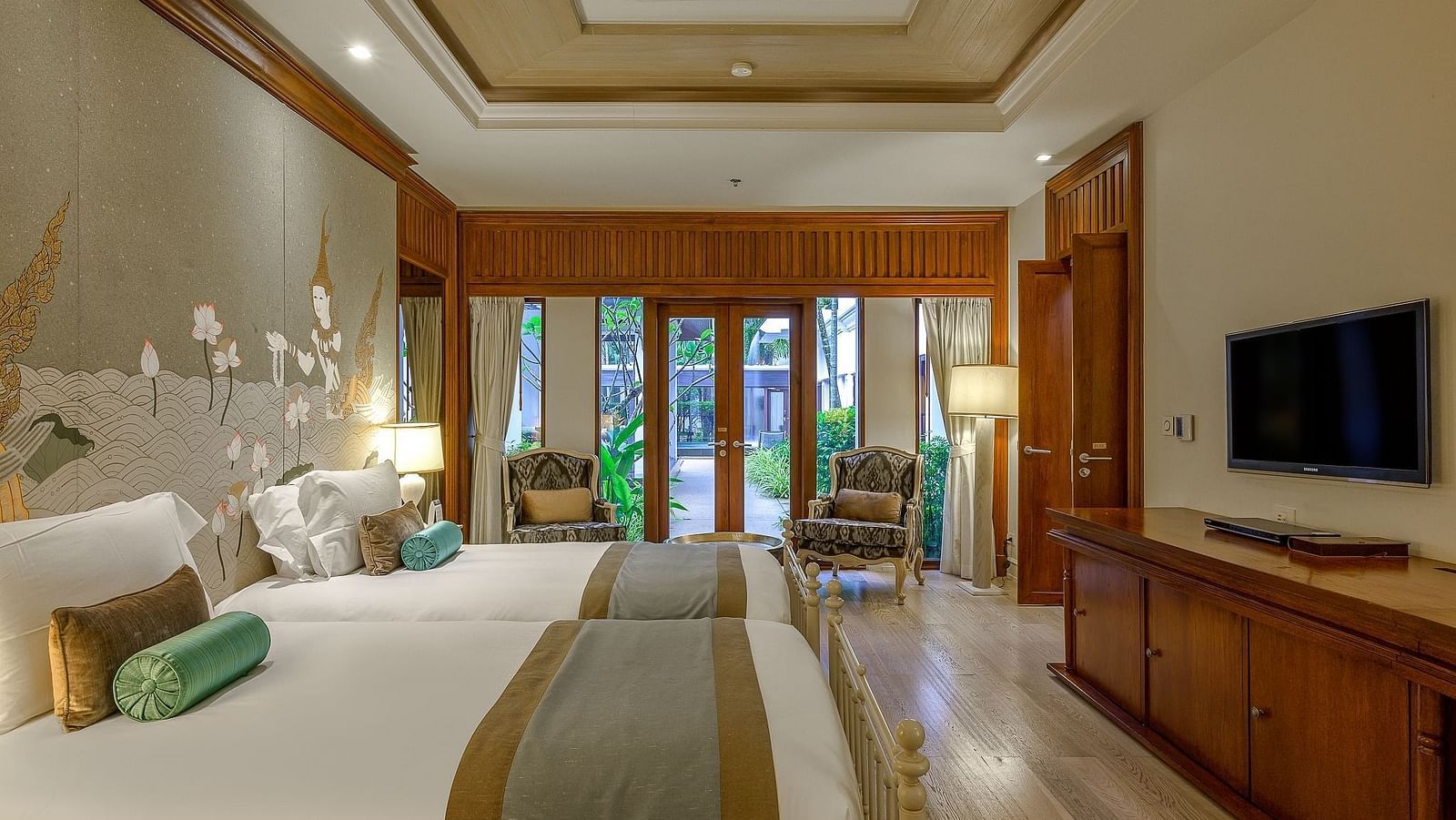Twin bed hotel room with wooden accents, TV, and view of a green garden - Maikhao Dream Villa Resort & Spa, Phuket