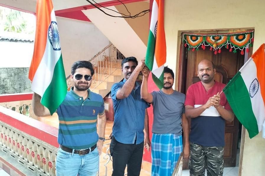 Four men holding Indian Flag at Coral Reef Hotel & Resort