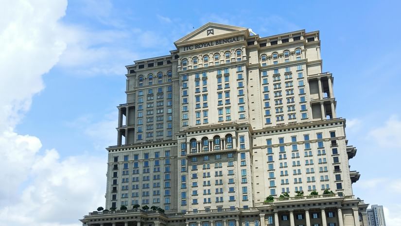 A tall building with classical-style architecture, seen from across a road with striped barriers in the foreground.