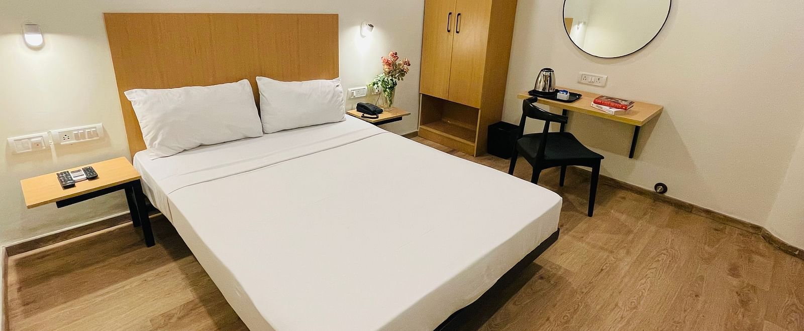 A double bed and a work desk at Sanctum Suites Richmond Road, Bangalore