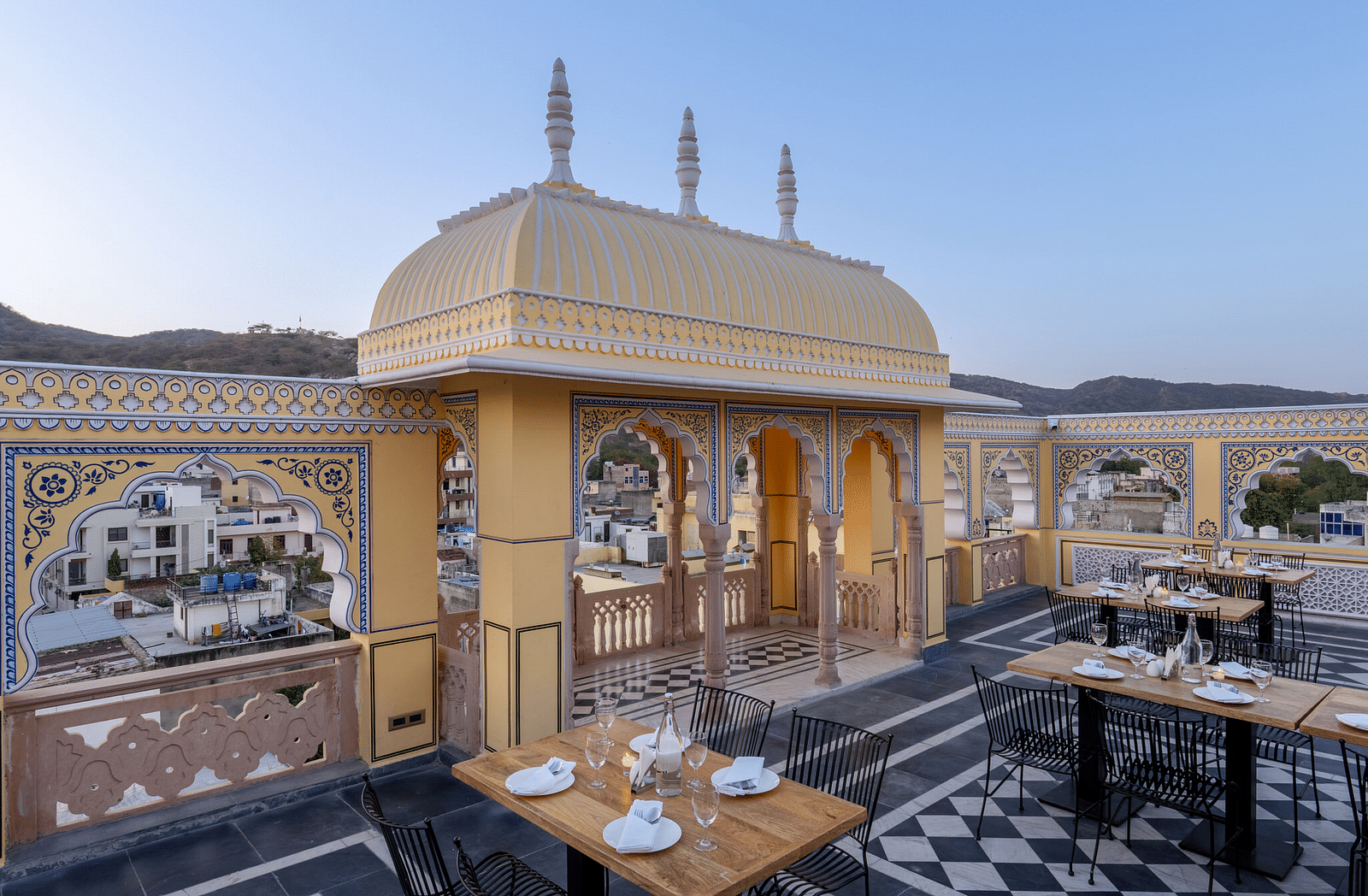 side view image featuring the balcony on the rooftop besides the dining area with three arched entrance - Brij Castle, Jaipur