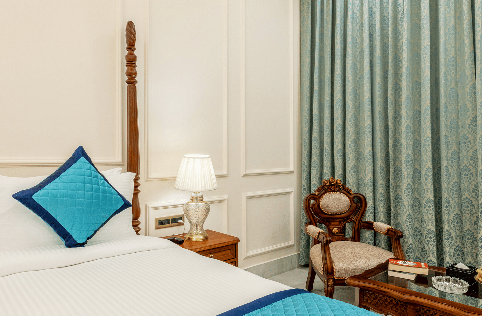 close up image of the bed overlooking an arm chair along with a bed side table beside it - Brij Castle, Jaipur