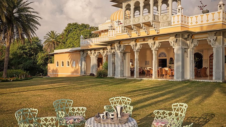 facade image of Dev Shree during the day with an outdoor seating area in the foreground