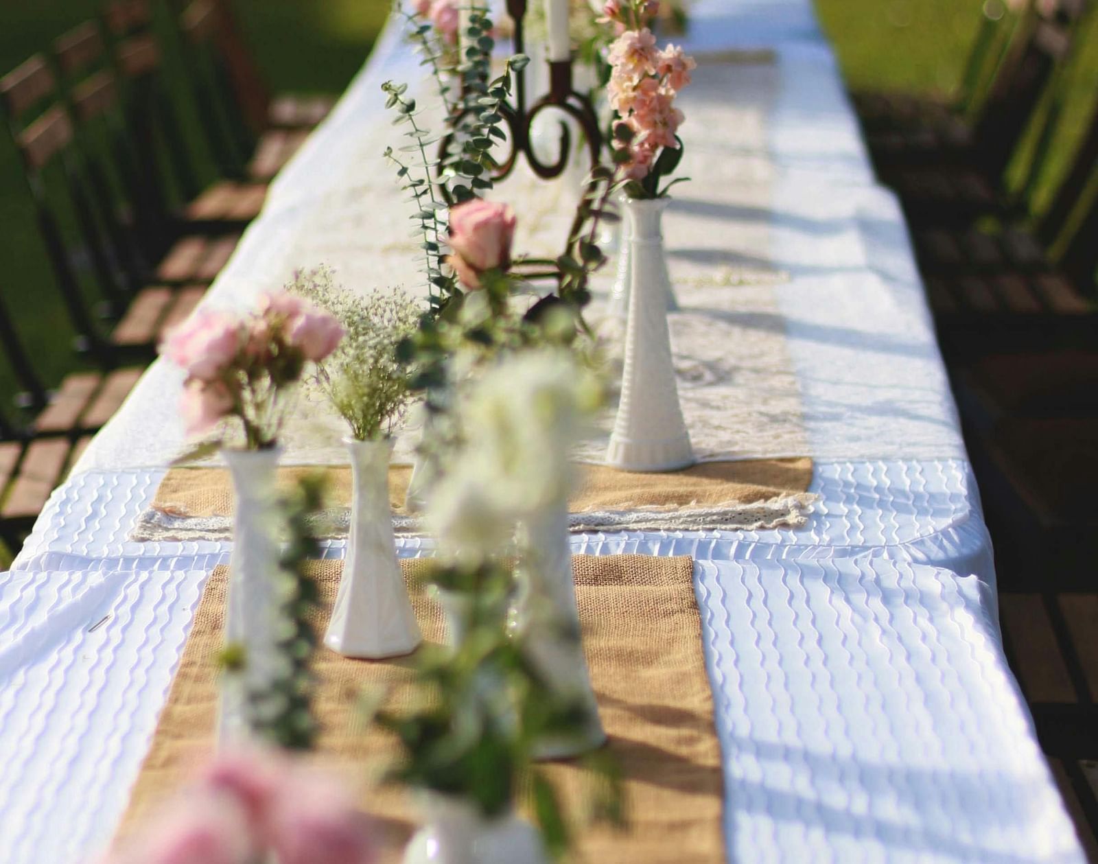 an outdoor dining arrangement in a garden during the day - The Groveland Hotel.