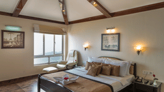 a well made bed at one of the rooms 14