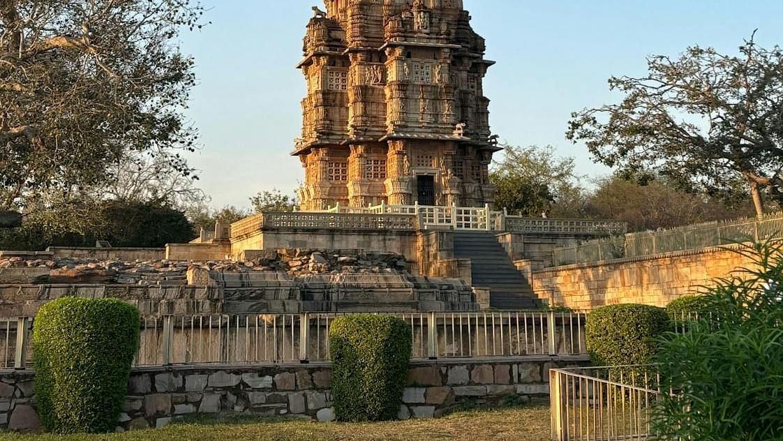 A tall, intricately carved tower rises against a clear sky.
