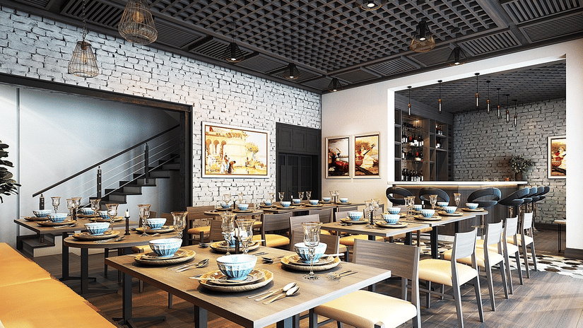 A contemporary dining area with many tables and chairs set up for meals in an open-plan space.