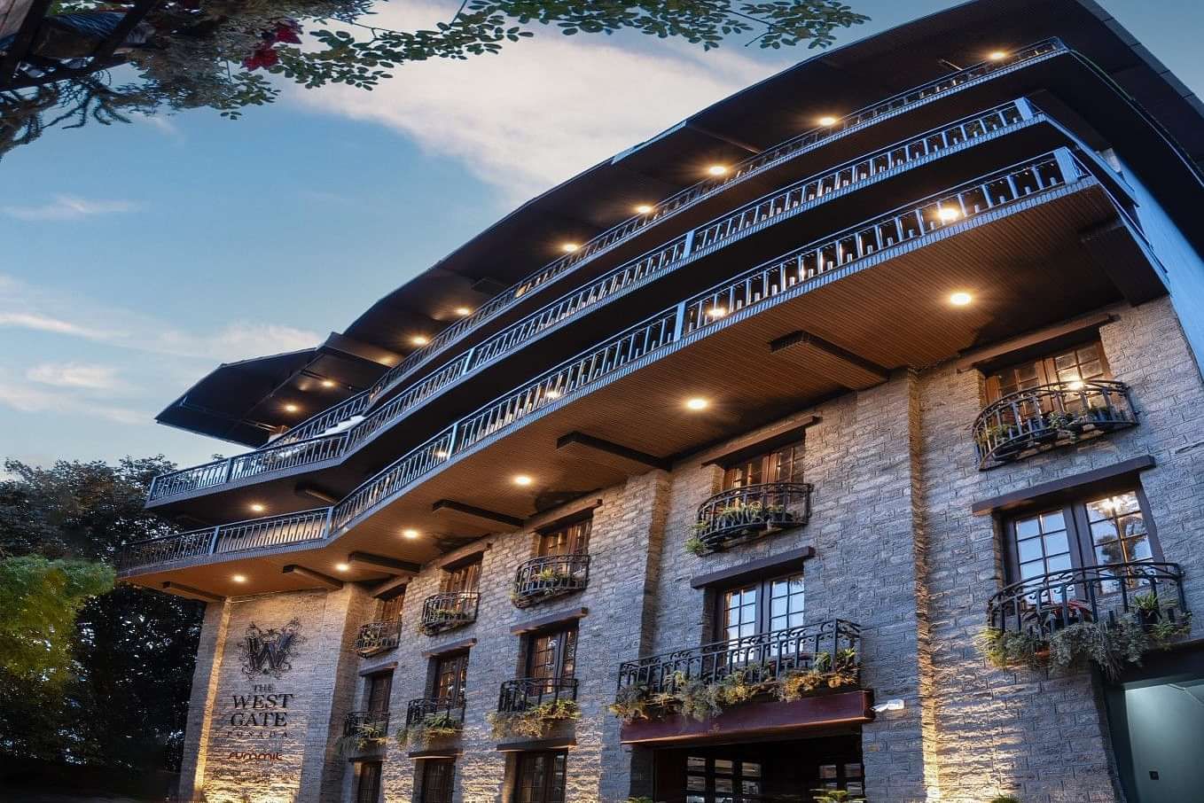 Shot of the facade of the hotel during the evening with a backdrop of blue sky.