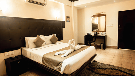 A spacious and elegant Executive Suite with a large bed and contemporary decor at the Polo Hotel Shillong.