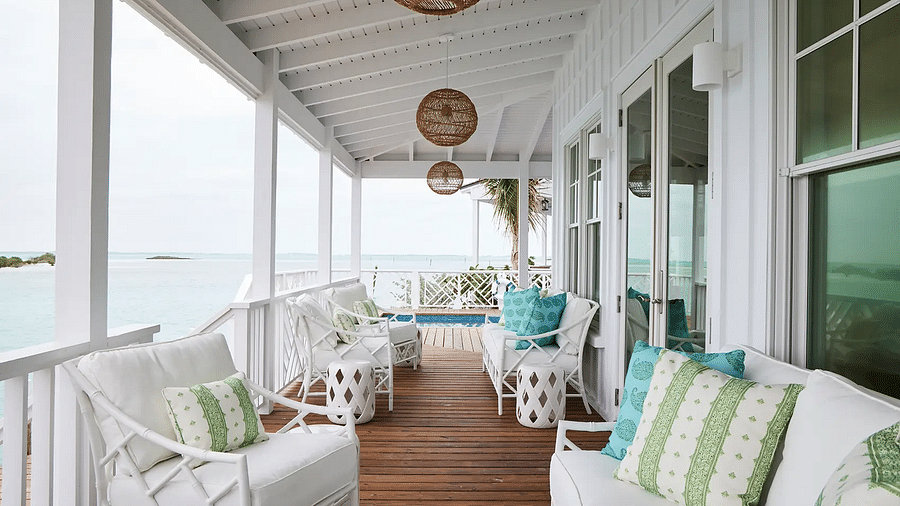 Porch with cushioned seating offering a view of the water | Abaco Inn