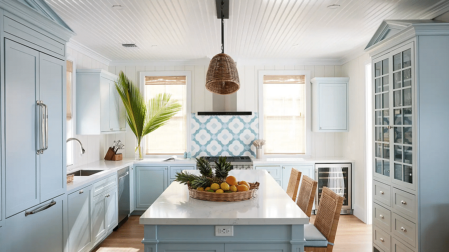 Kitchen with blue cabinetry, island seating, and modern appliances | Abaco Inn