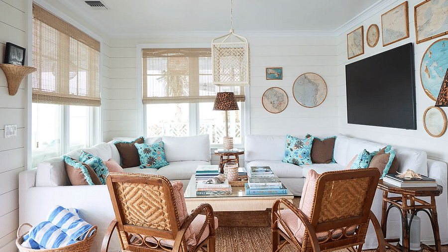 Living room with wicker chairs, coastal decor, and a large TV | Abaco Inn