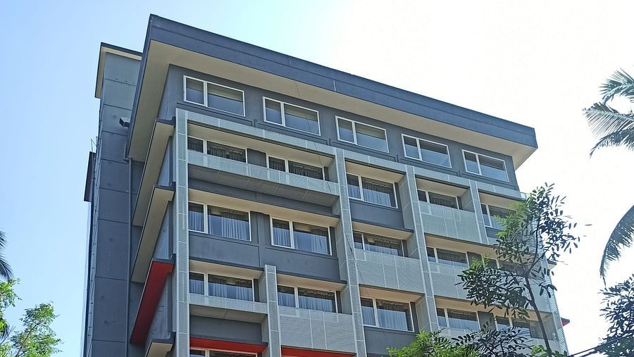 A modern multi-story building viewed from the street during the day - TGI Ameya Grand, Goa