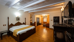 Side view of Balcony Room with a cosy bed at The Pavilion, Nainital