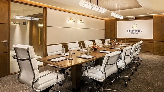 Board room at The Residency Towers Puducherry, featuring a long table with chair seating.