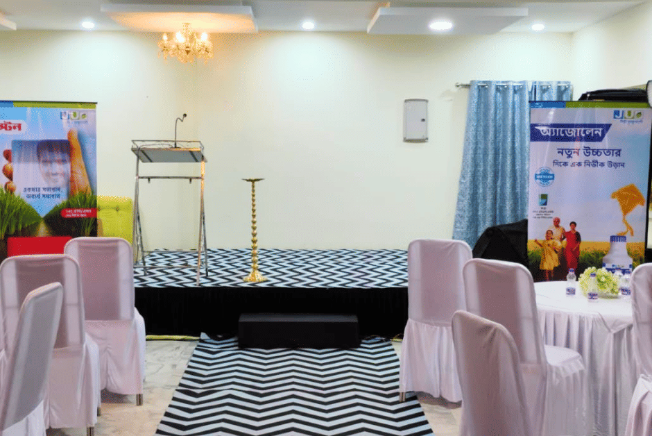 Banquet hall at Shophori Wellness Retreat, Santiniketan, set up for an intimate event with chandelier lighting