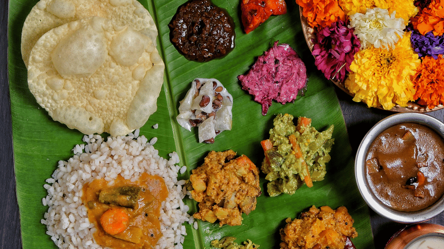Lavish Onam sadya displayed on a banana leaf with rice, curries, sweets, and traditional vegetarian dishes served during celebrations