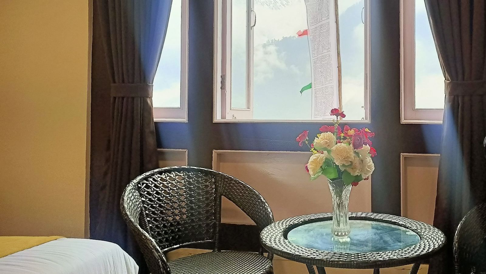 Deluxe Room at Ecotel Sonam Lachung decked with a chair and tea table