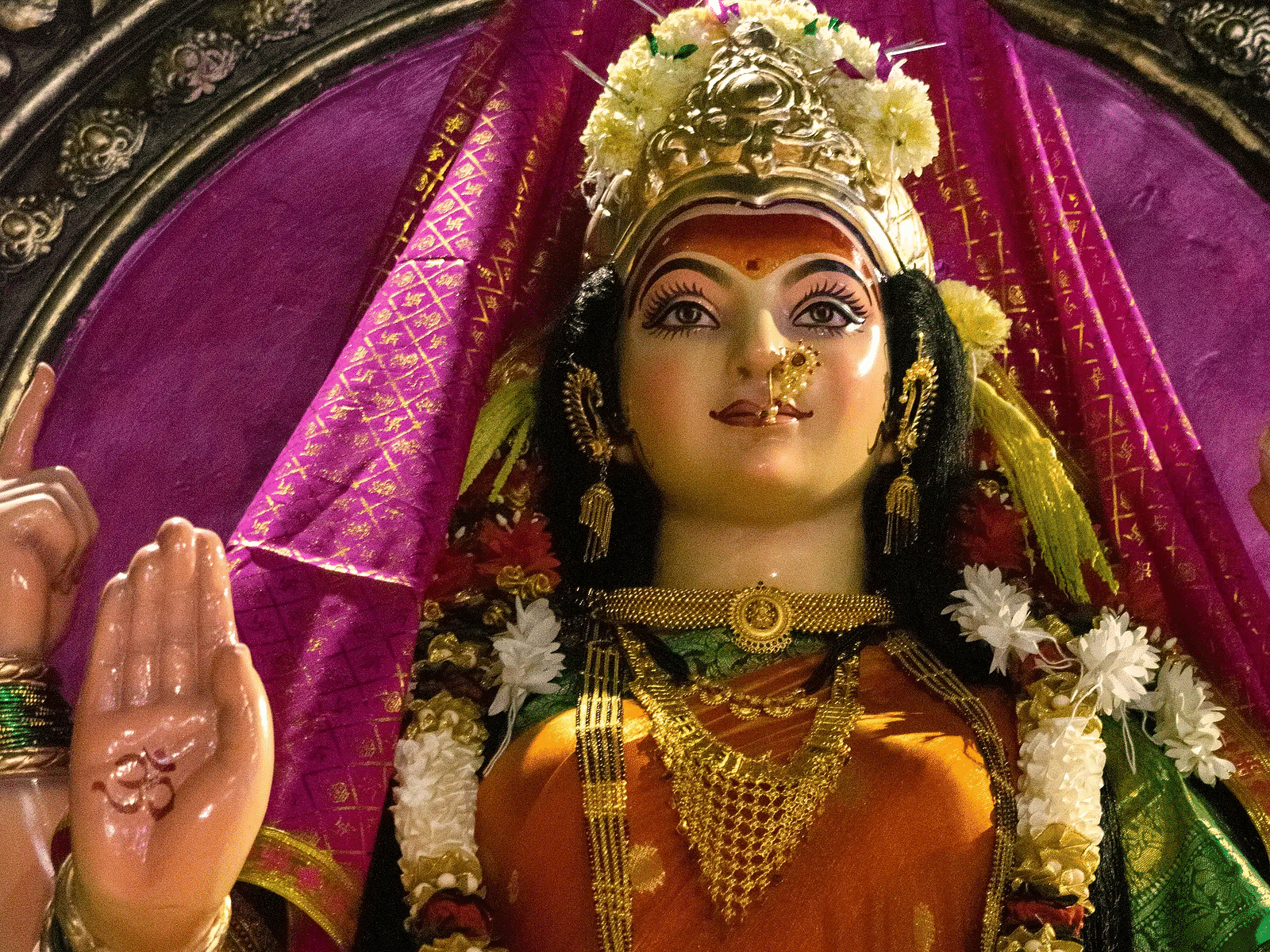 Colorful idol of a Hindu goddess in a temple.