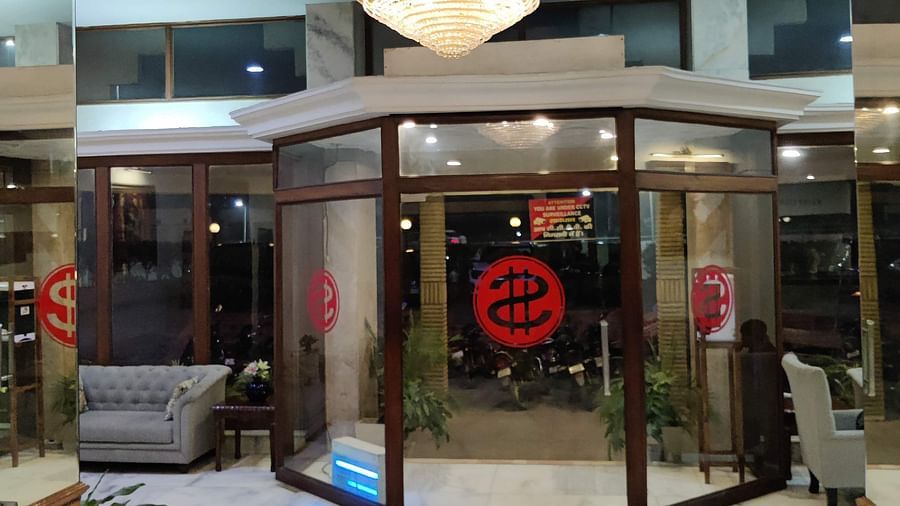 Interior view of the entrance of Hotel Gold, Panipat with a chandelier hanging from the ceiling in the lobby during late eveing.