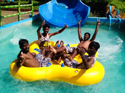 A group of people inside a raft at family raft slide at Black Thunder, Coimbatore.