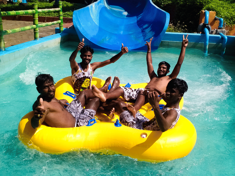 A group of people inside a raft at family raft slide at Black Thunder, Coimbatore.