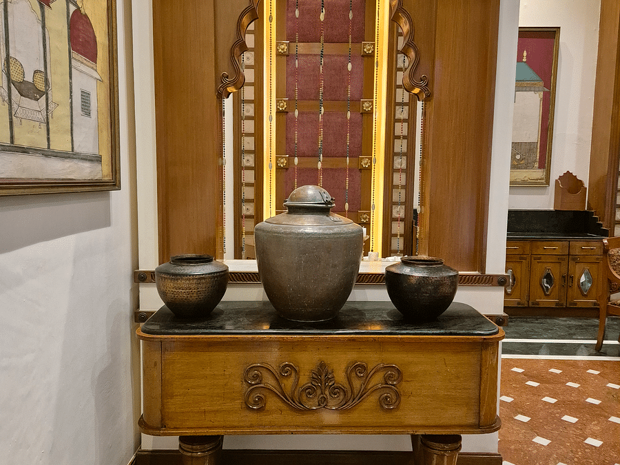 Front view of Kesar's antique pieces, surrounded by elegantly crafted wooden furnishings at The Ummed Ahmedabad.