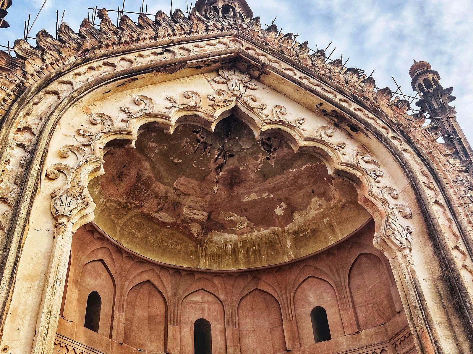 Low-angle view of an intricately designed historical monument with sky in the background