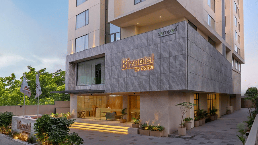 Picture featuring the facade of Pride Plaza Ahmedabad in the bright day time.