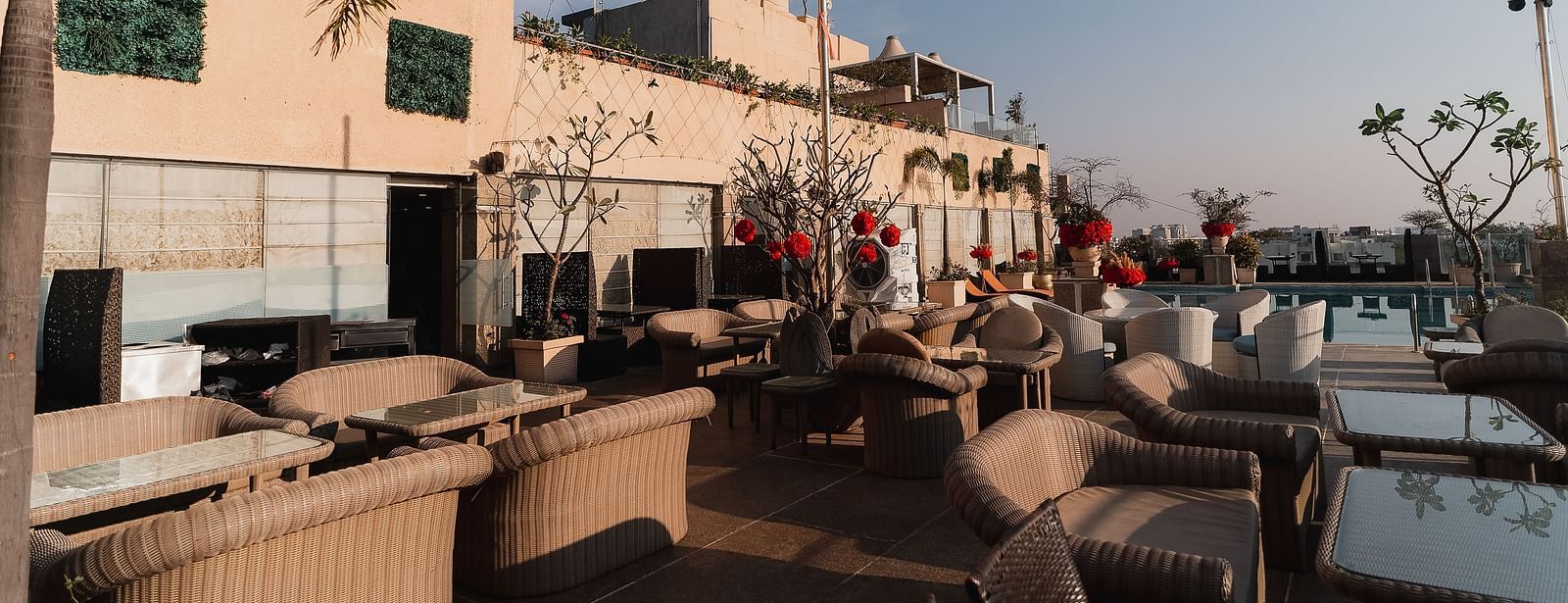 An outdoor seating area, possibly at a restaurant with tables and chairs at Hotel Ashok Nagpur.